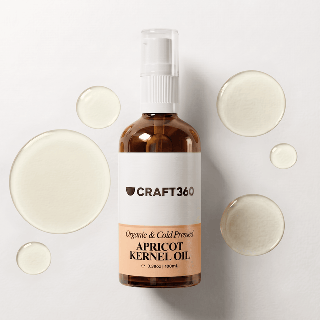 100 ml bottle of Apricot Kernel Oil surrounded by pools of pale golden oil