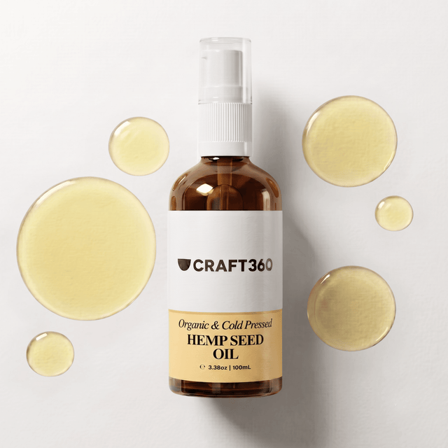 100 ml bottle of Organic Golden Hemp Seed Oil surrounded by pools of golden oil