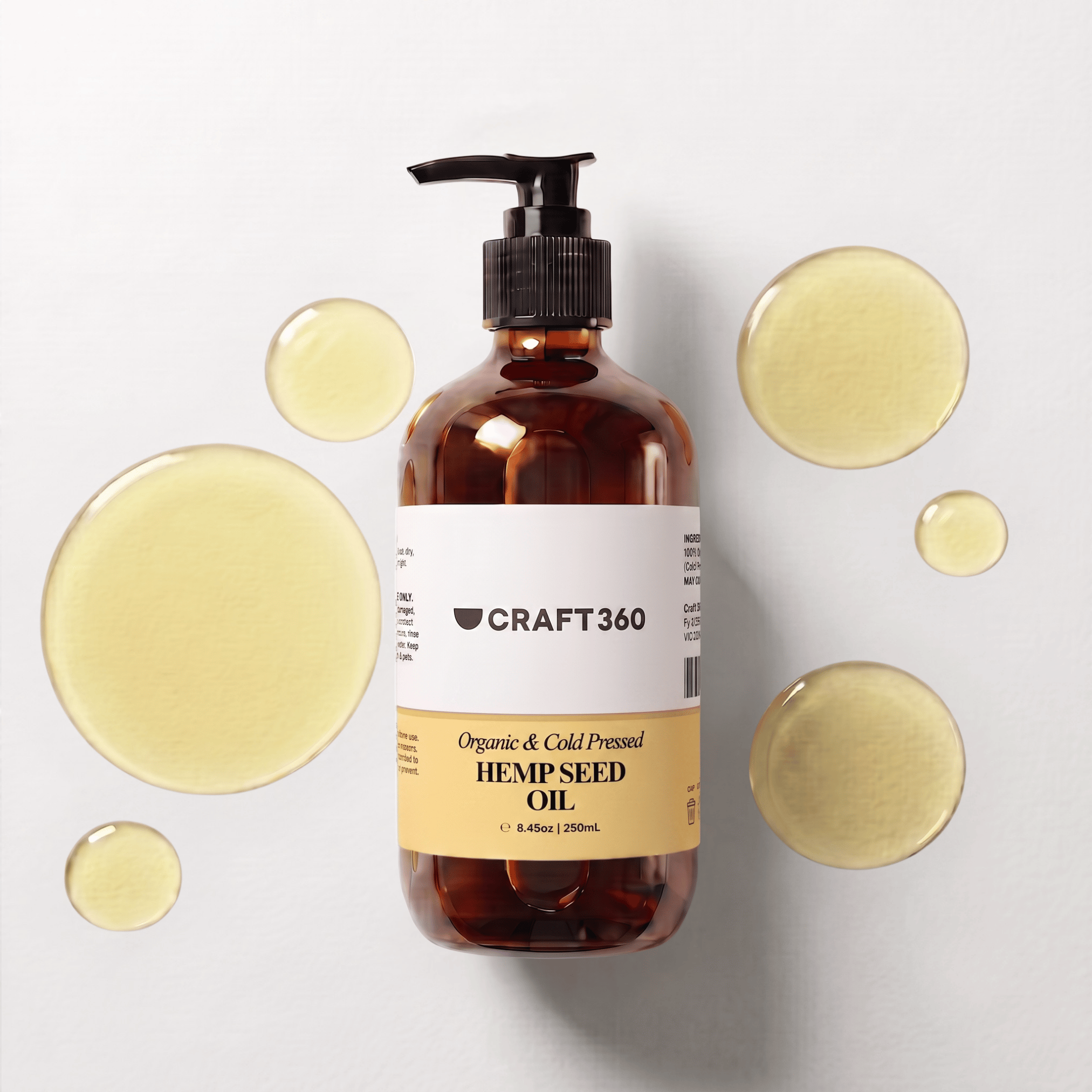 250 ml bottle of Organic Golden Hemp Seed Oil surrounded by pools of golden oil